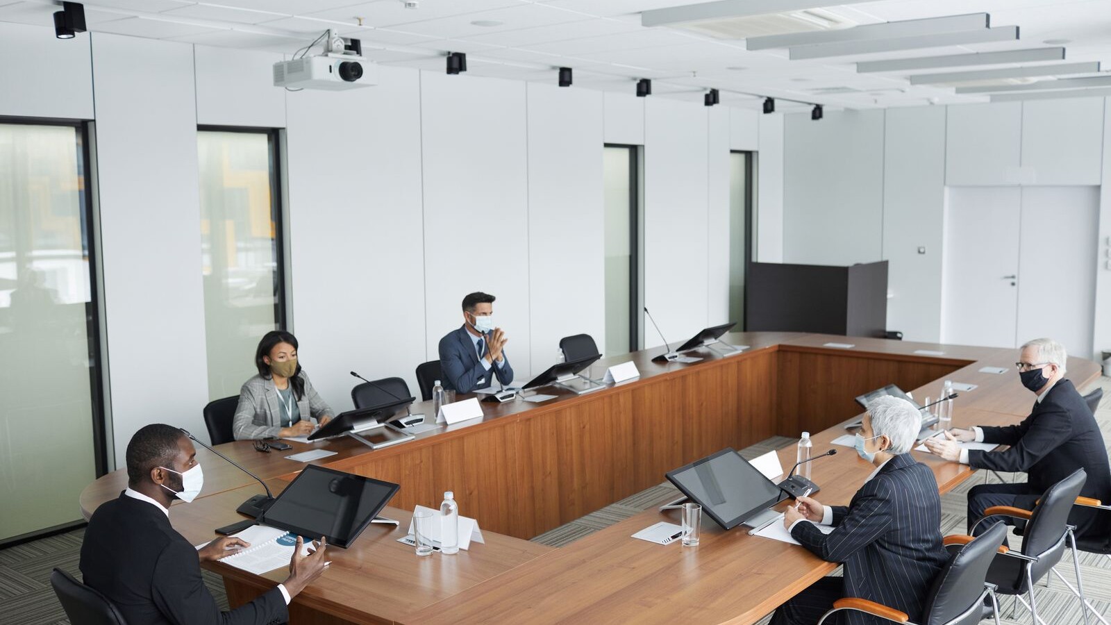 Boardroom meeting illustrating how director remuneration is taxed across borders
