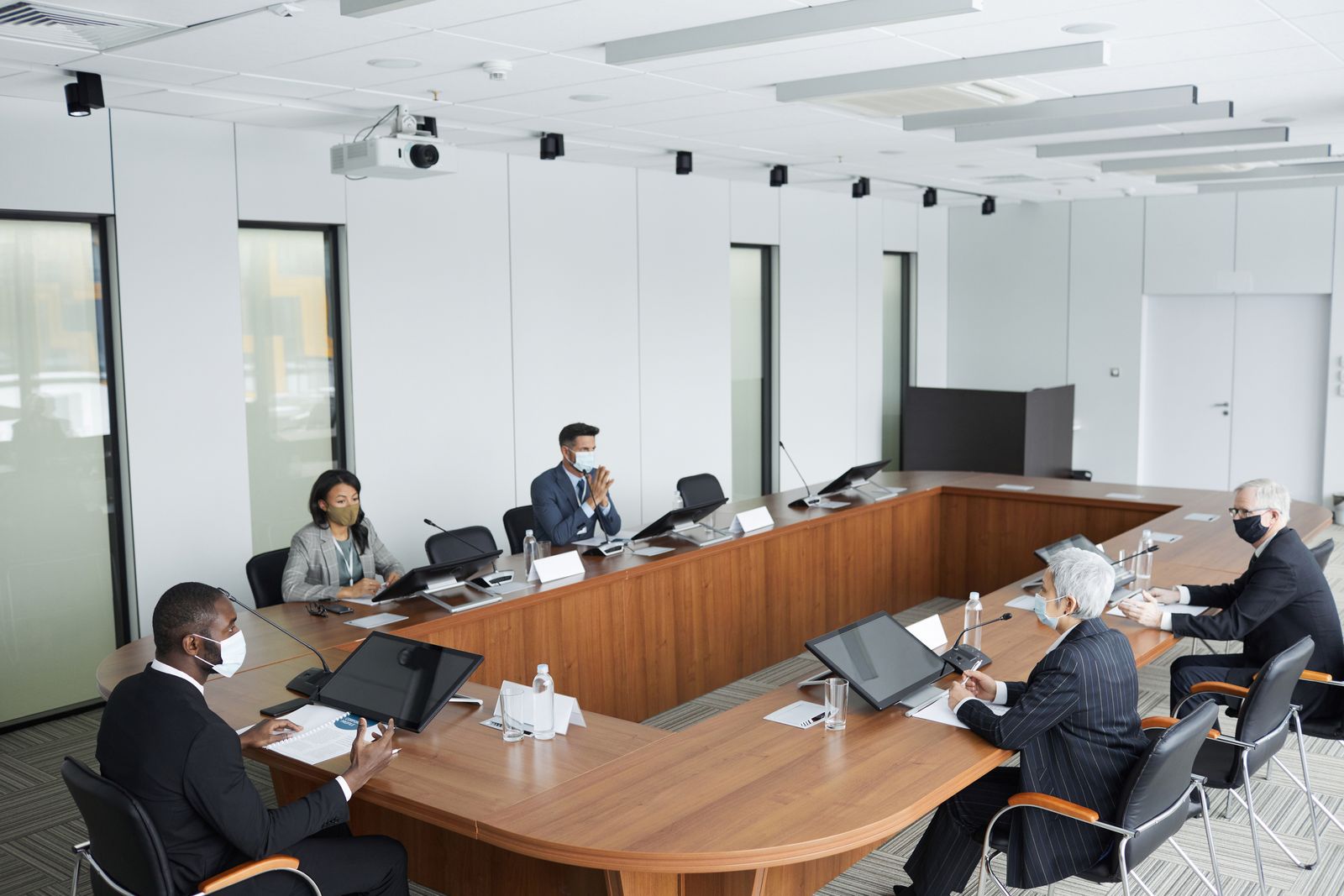 Boardroom meeting illustrating how director remuneration is taxed across borders